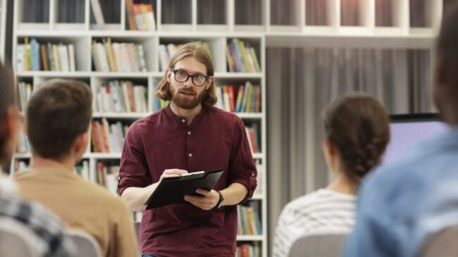 Teacher With Students In The Library